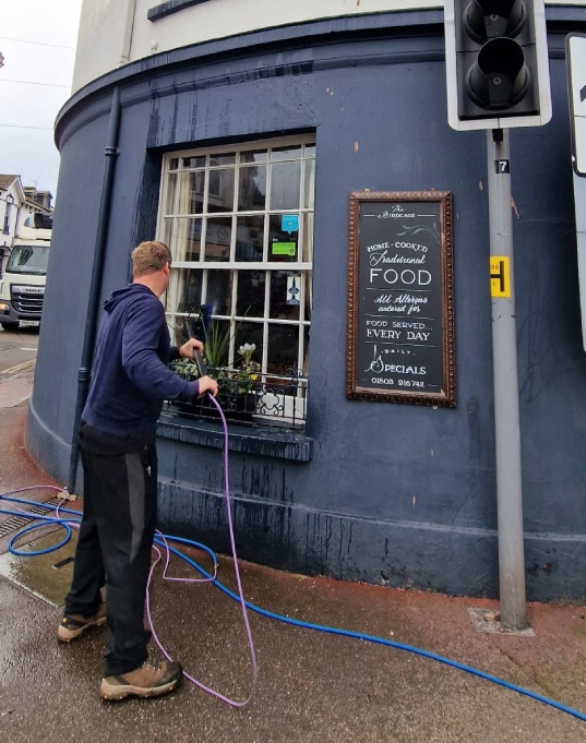 MD Elite Cleaning Team Member Cleaning a Commercial Window
